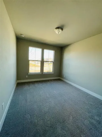 an empty room with a empty space and windows