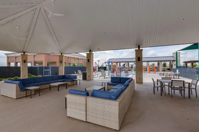 deck with table and chairs under an umbrella