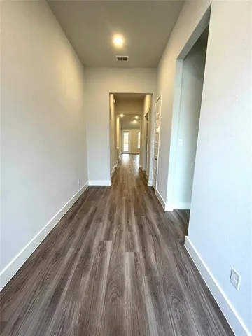 a view of a room with wooden floor