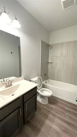 a bathroom with a double vanity sink toilet and shower