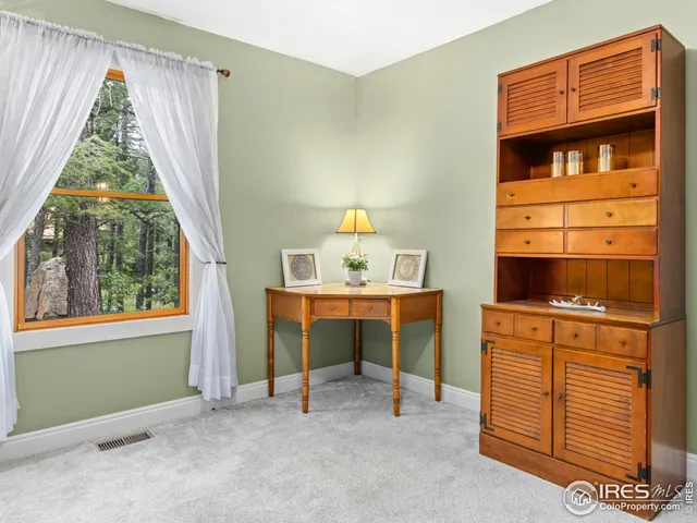 a view of room with window and cabinet
