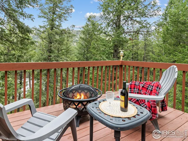 a view of a balcony with two chairs and a table