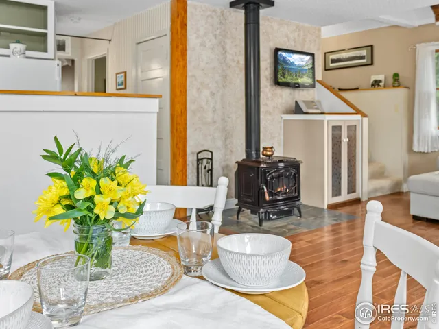 a dining room with furniture and a potted plant