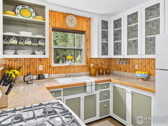 a view of a kitchen with a sink and a window