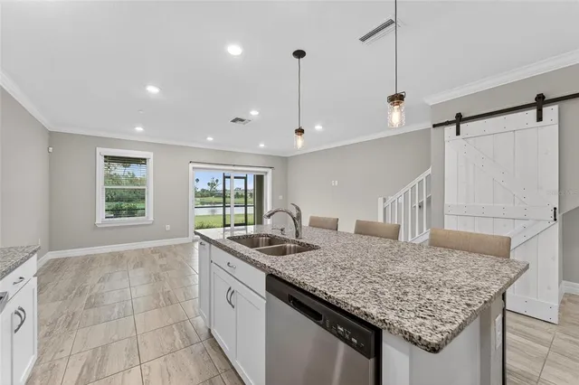 a kitchen with stainless steel appliances granite countertop a sink stove and kitchen island