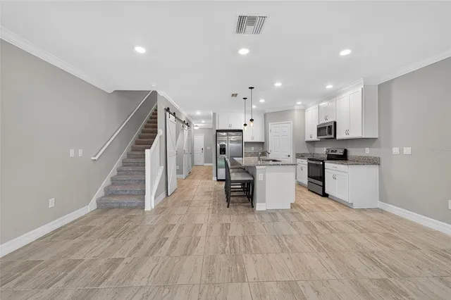 a view of kitchen with wooden floor and electronic appliances