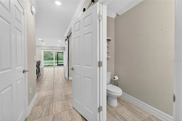 a bathroom with a granite countertop shower a toilet and a sink