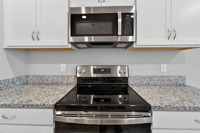 a stove top oven sitting inside of a kitchen