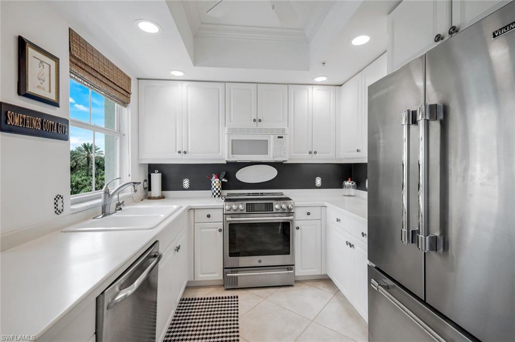 315 Dunes Boulevard, Unit 307 Naples, FL 34110 - Photo 12 of 44 a kitchen with a stove sink and refrigerator