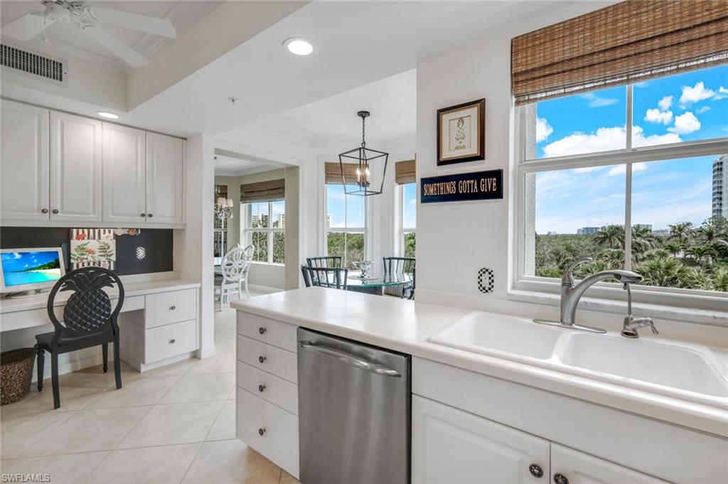 315 Dunes Boulevard, Unit 307 Naples, FL 34110 - Photo 13 of 44 a kitchen with a sink cabinets and window