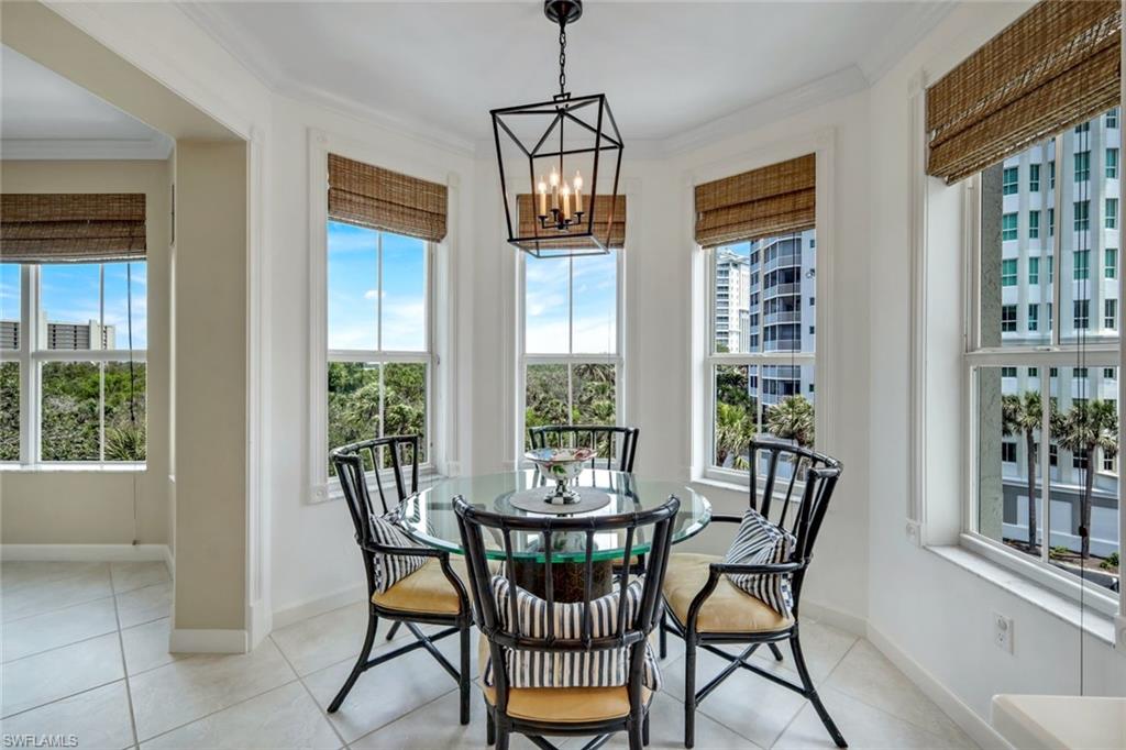 315 Dunes Boulevard, Unit 307 Naples, FL 34110 - Photo 15 of 44 a view of a dining room with furniture window and outside view