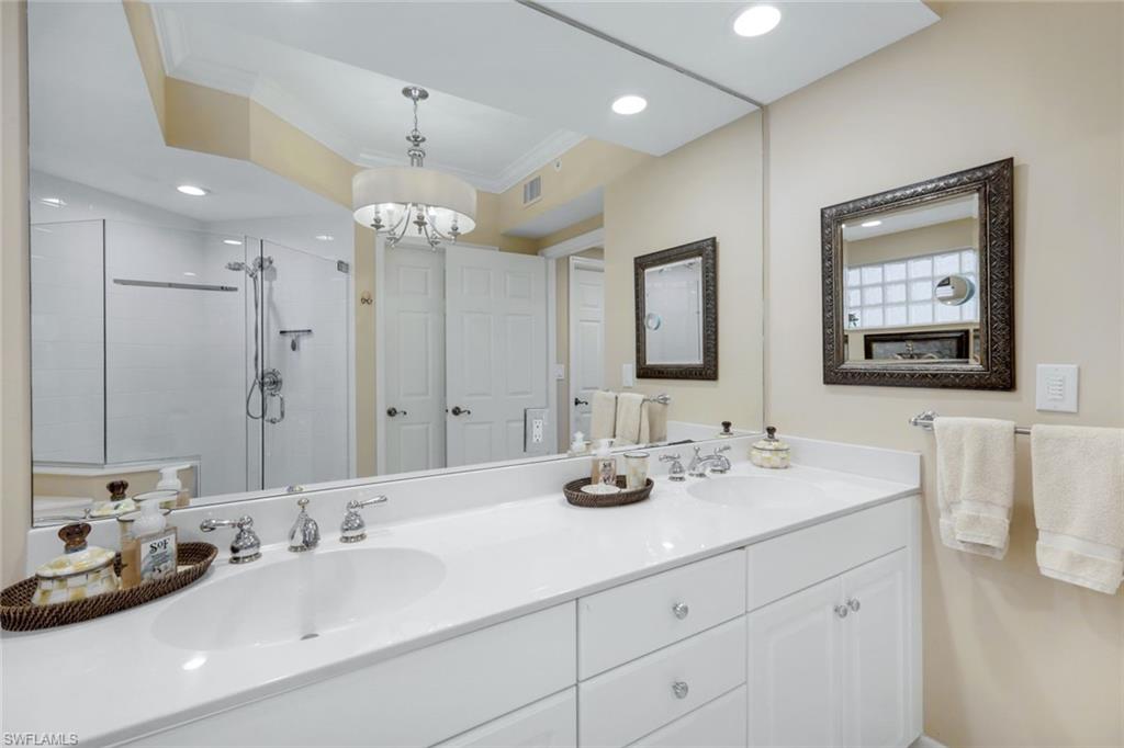 315 Dunes Boulevard, Unit 307 Naples, FL 34110 - Photo 20 of 44 a bathroom with double vanity sinks and a mirror