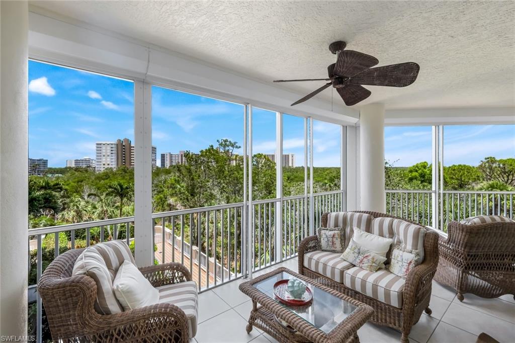 315 Dunes Boulevard, Unit 307 Naples, FL 34110 - Photo 2 of 44 a living room with furniture and a floor to ceiling window