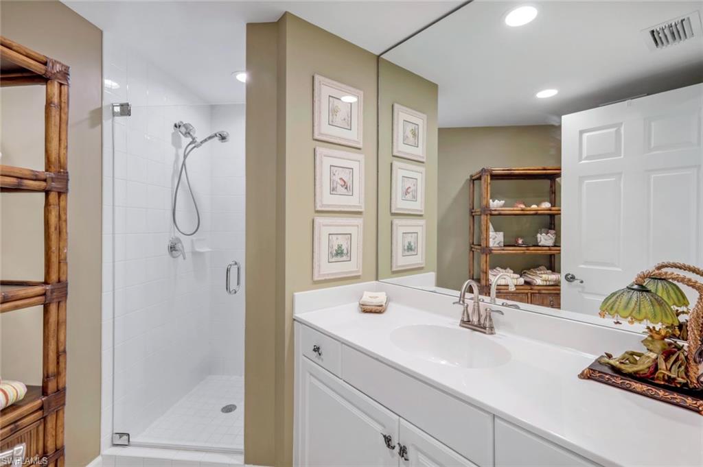 315 Dunes Boulevard, Unit 307 Naples, FL 34110 - Photo 25 of 44 a bathroom with a shower sink and mirror