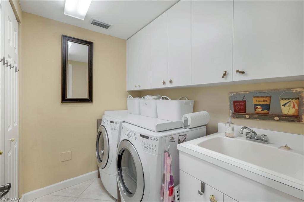 315 Dunes Boulevard, Unit 307 Naples, FL 34110 - Photo 26 of 44 a utility room with dryer and washer