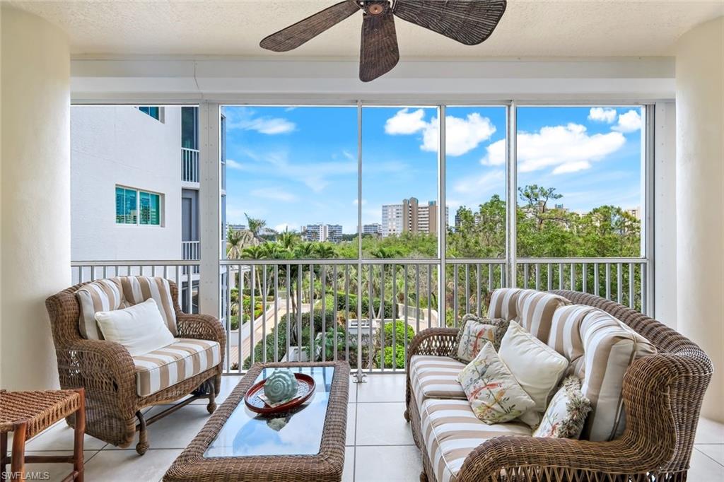 315 Dunes Boulevard, Unit 307 Naples, FL 34110 - Photo 27 of 44 a balcony with furniture and a floor to ceiling window