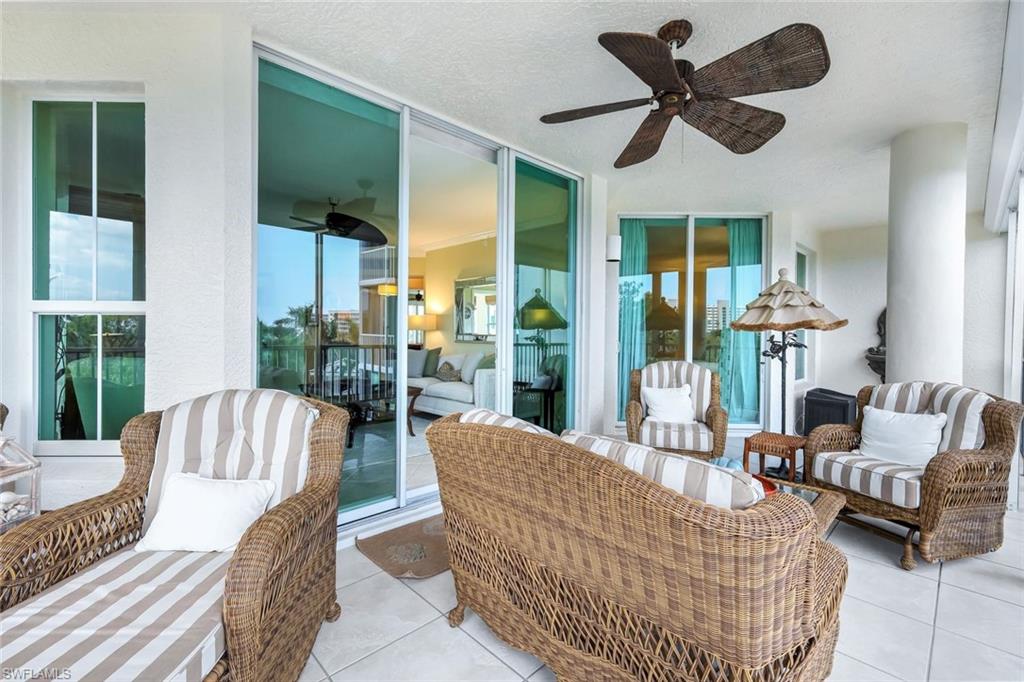 315 Dunes Boulevard, Unit 307 Naples, FL 34110 - Photo 29 of 44 a living room with furniture and a large window
