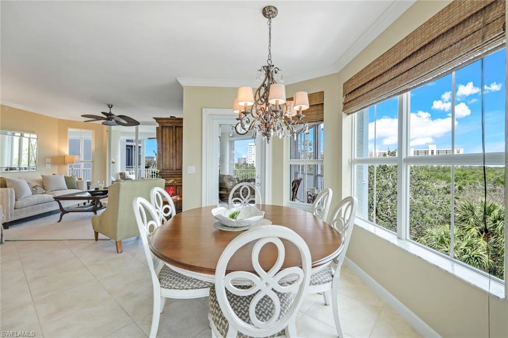 315 Dunes Boulevard, Unit 307 Naples, FL 34110 - Photo 9 of 44 a dining room with furniture a chandelier and window