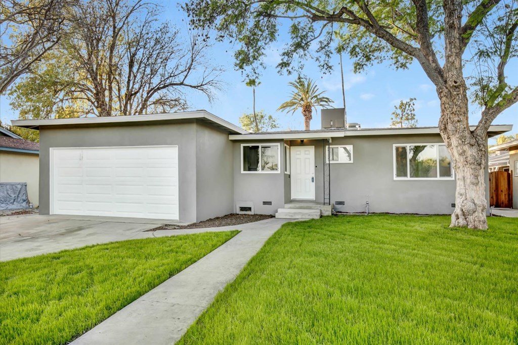 5863 Normandie Place Riverside, CA 92504 - Photo 1 of 1 a front view of a house with a yard and garage
