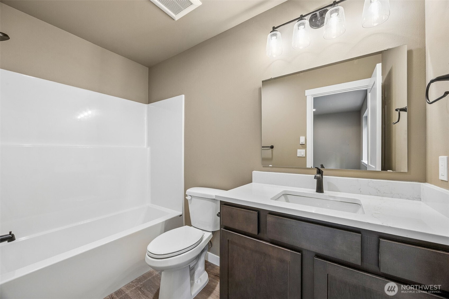 18410 Rampart Drive Southeast Yelm, WA 98597 - Photo 18 of 30 a bathroom with a sink a toilet a mirror and shower