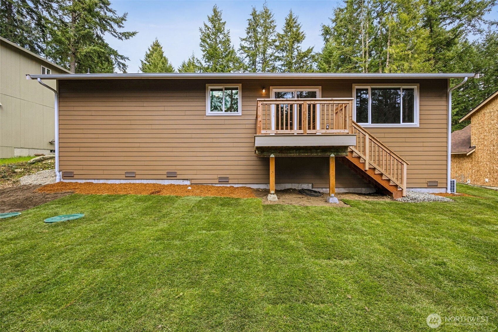 18410 Rampart Drive Southeast Yelm, WA 98597 - Photo 19 of 30 a view of a house with a yard and a deck
