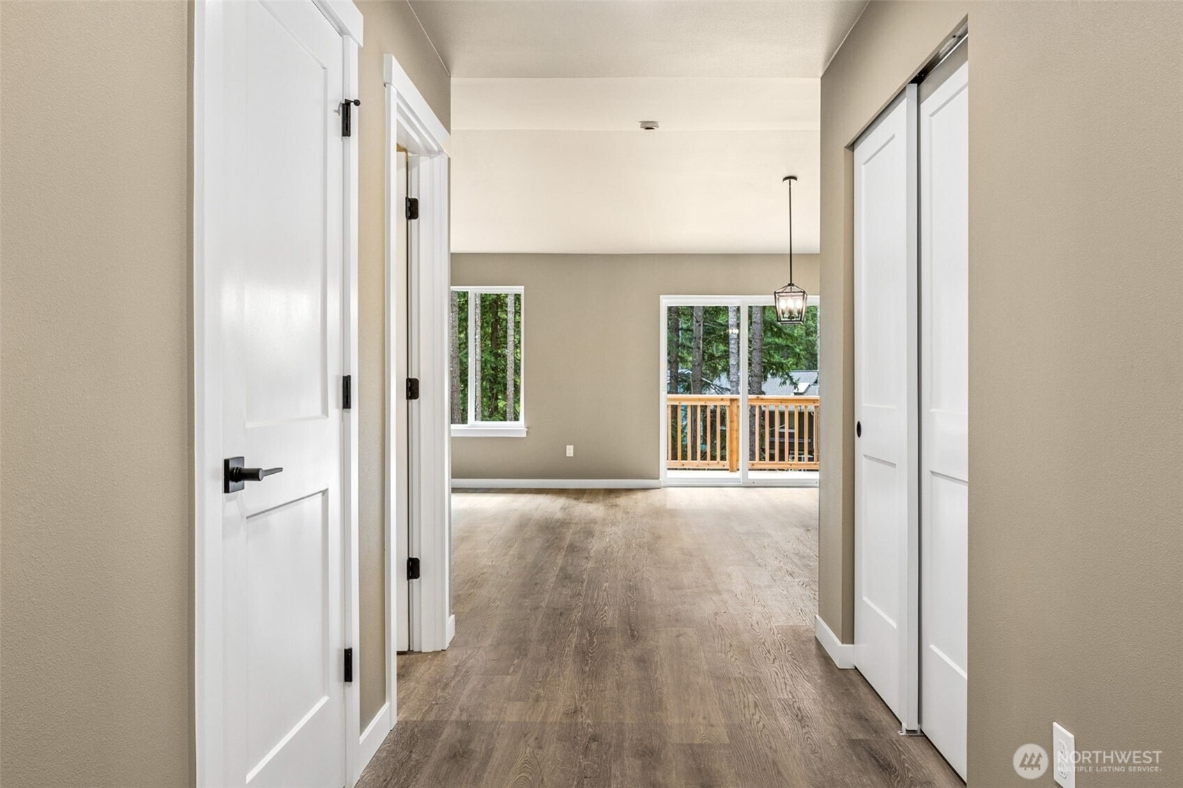 18410 Rampart Drive Southeast Yelm, WA 98597 - Photo 3 of 30 a view of an empty room with wooden floor and a window