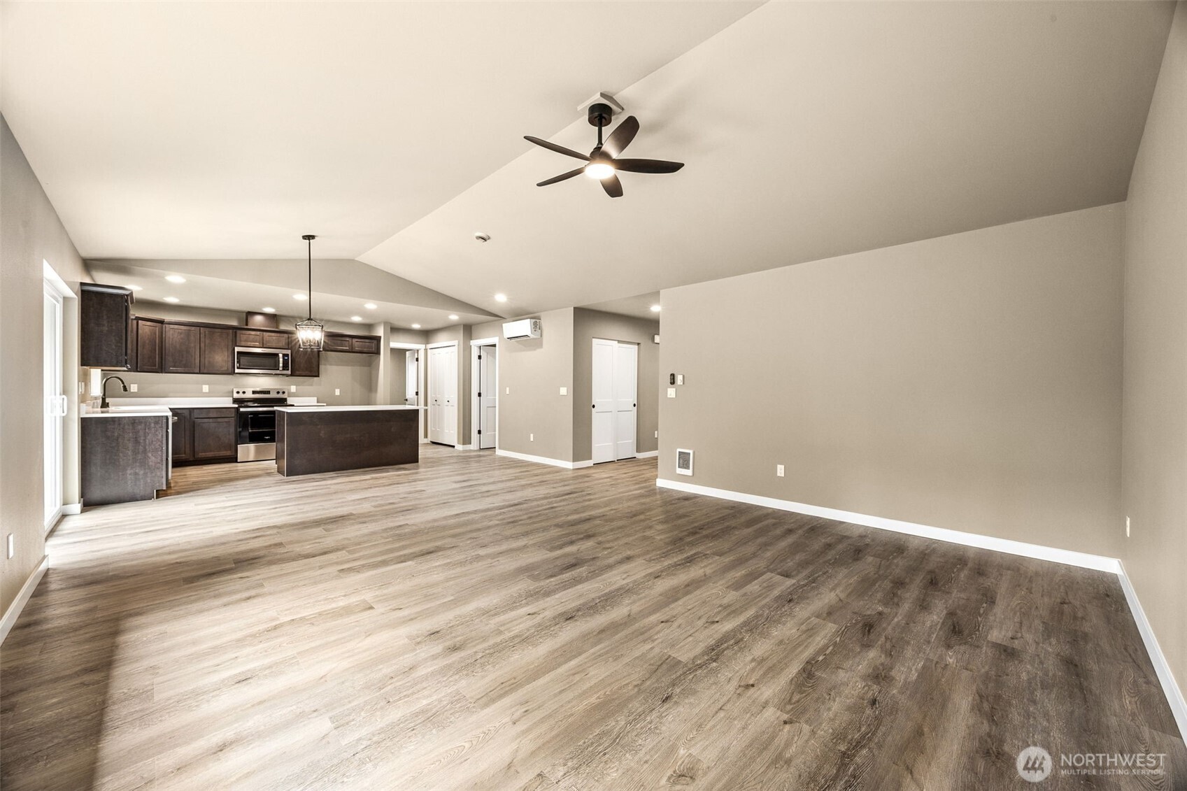 18410 Rampart Drive Southeast Yelm, WA 98597 - Photo 7 of 30 an empty room with kitchen appliances and a ceiling fan