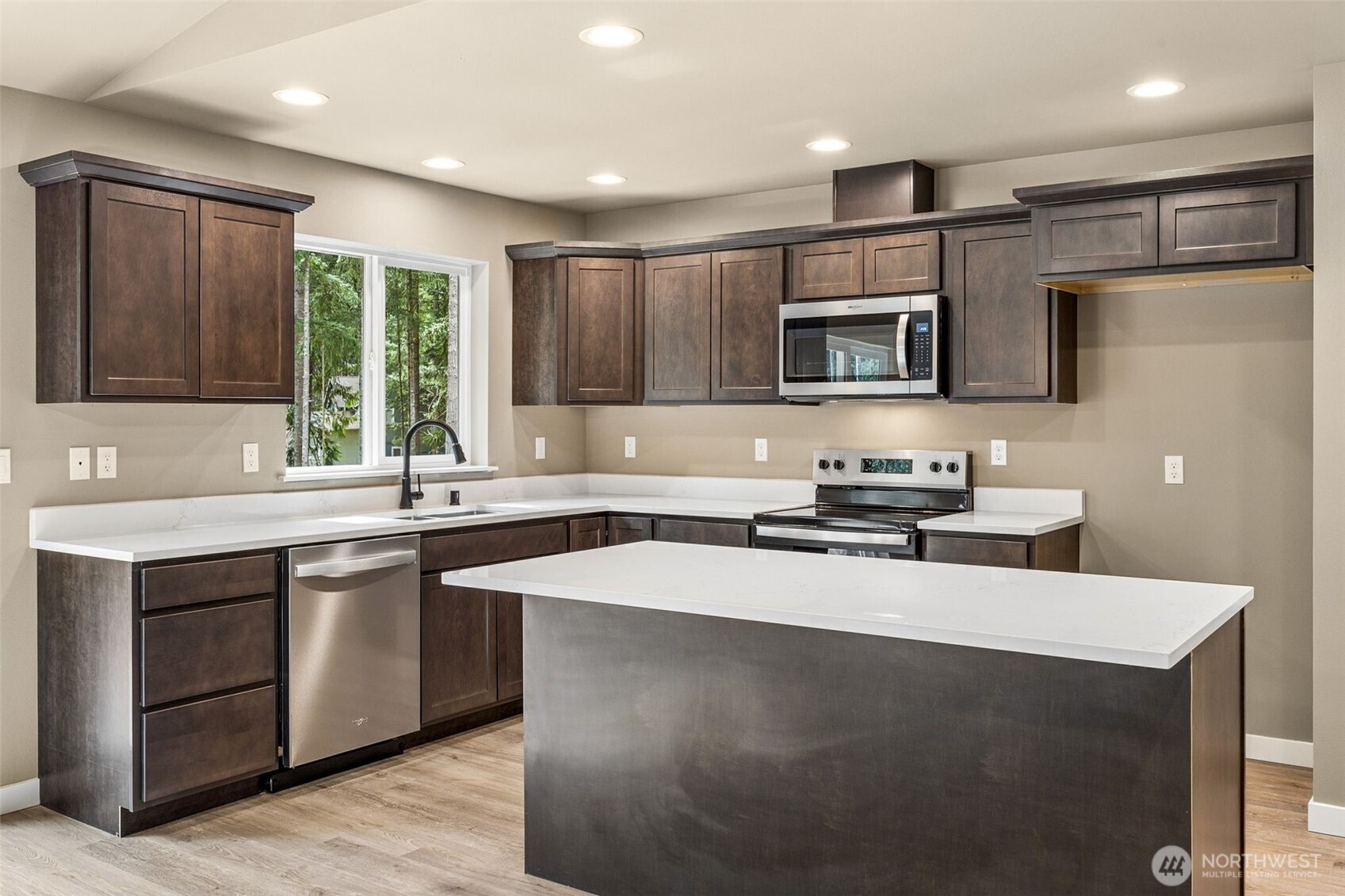 18410 Rampart Drive Southeast Yelm, WA 98597 - Photo 9 of 30 a kitchen with stainless steel appliances granite countertop a sink stove and refrigerator