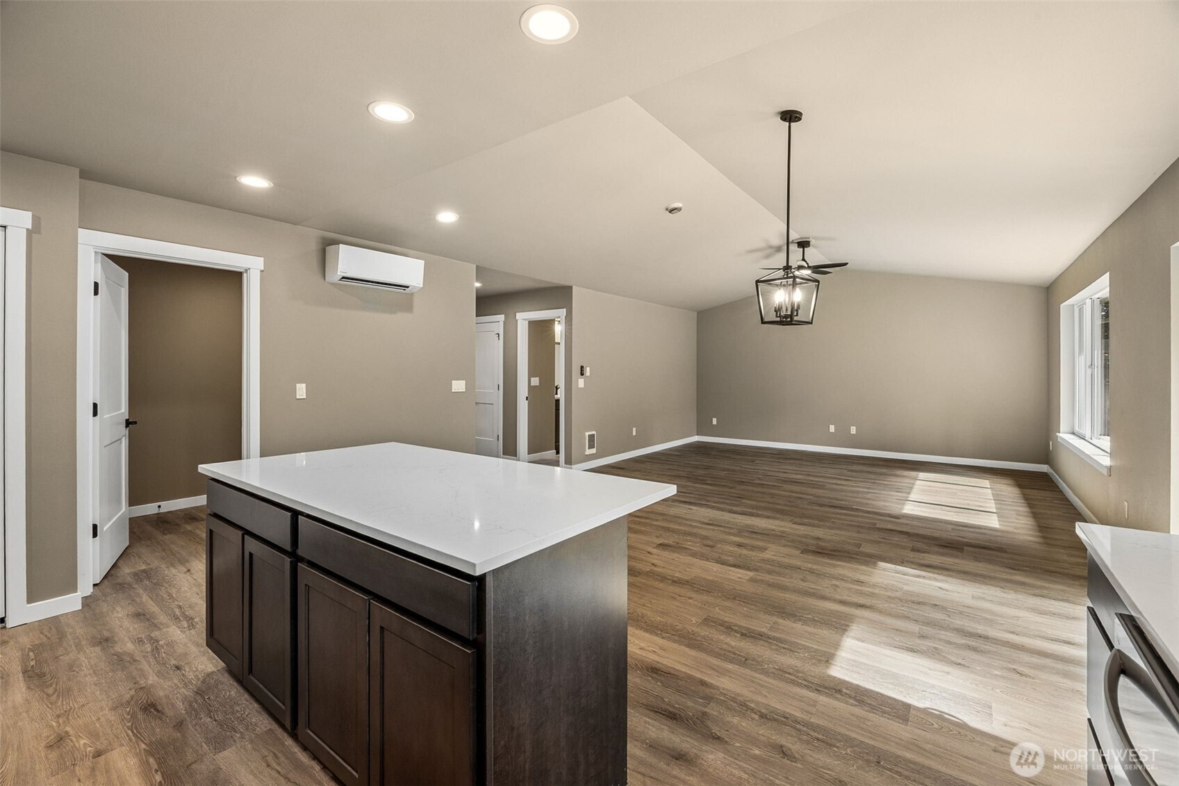 18410 Rampart Drive Southeast Yelm, WA 98597 - Photo 10 of 30 a room with a table chairs and wooden floor