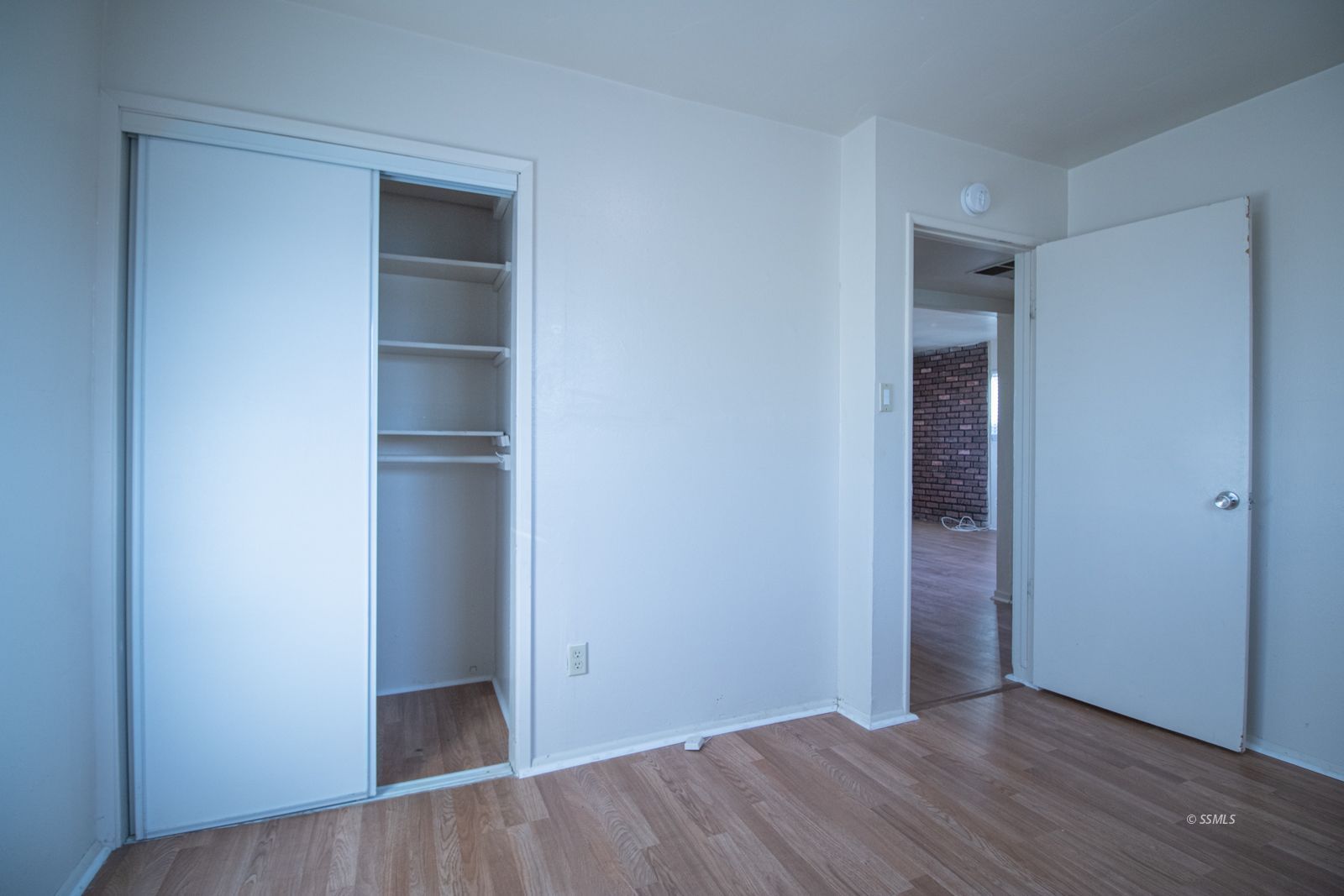 1621 Sims Street Ridgecrest, CA 93555 - Photo 16 of 24 a view of an empty room with wooden floor and closet