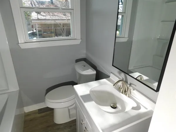 a white toilet sitting next to a bathroom sink