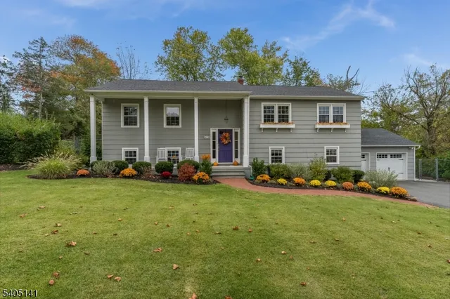 a view of a house with backyard sitting area and garden