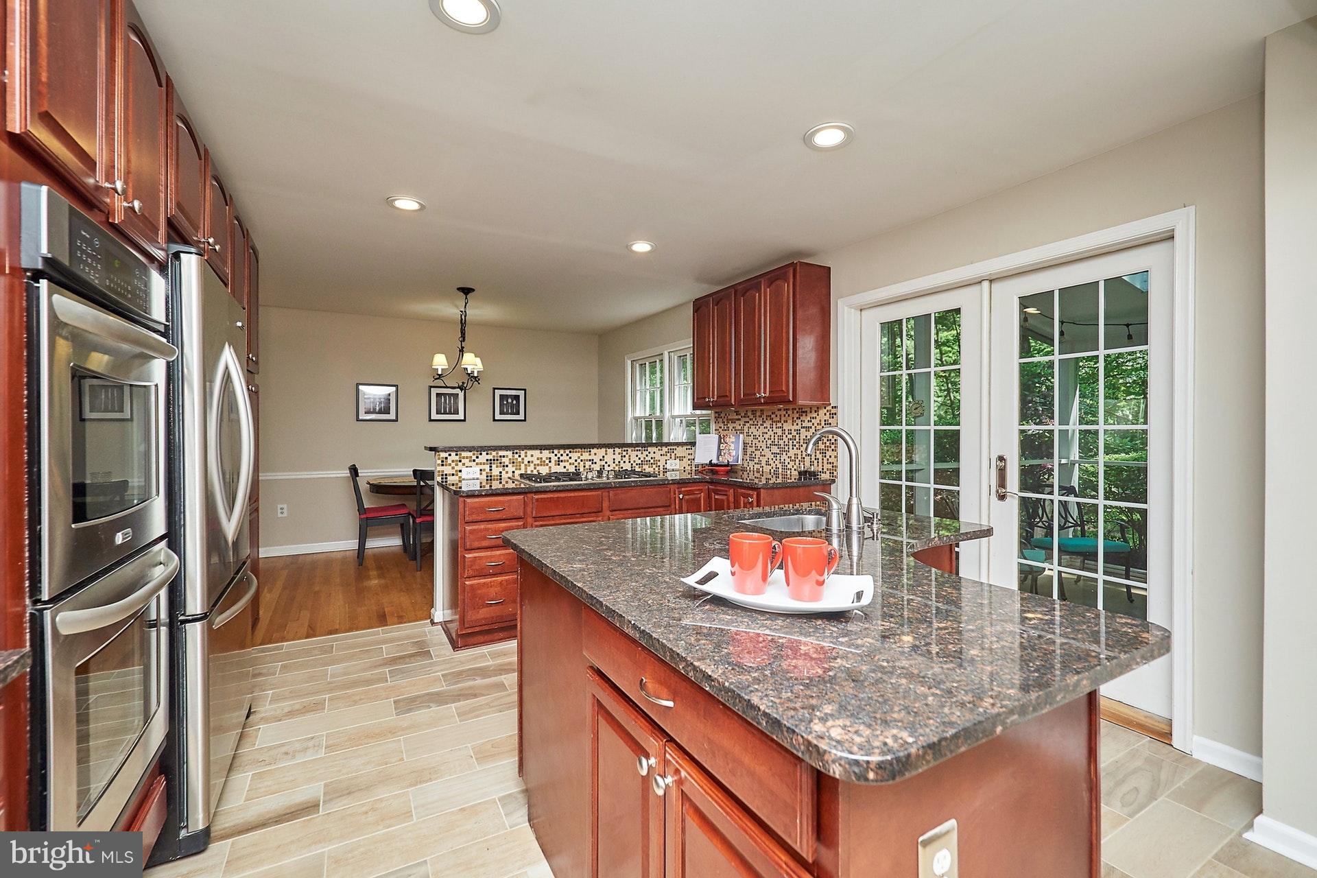 2421 Silver Fox Lane Reston, VA 20191 - Photo 3 of 27 a kitchen with stainless steel appliances granite countertop sink stove and refrigerator