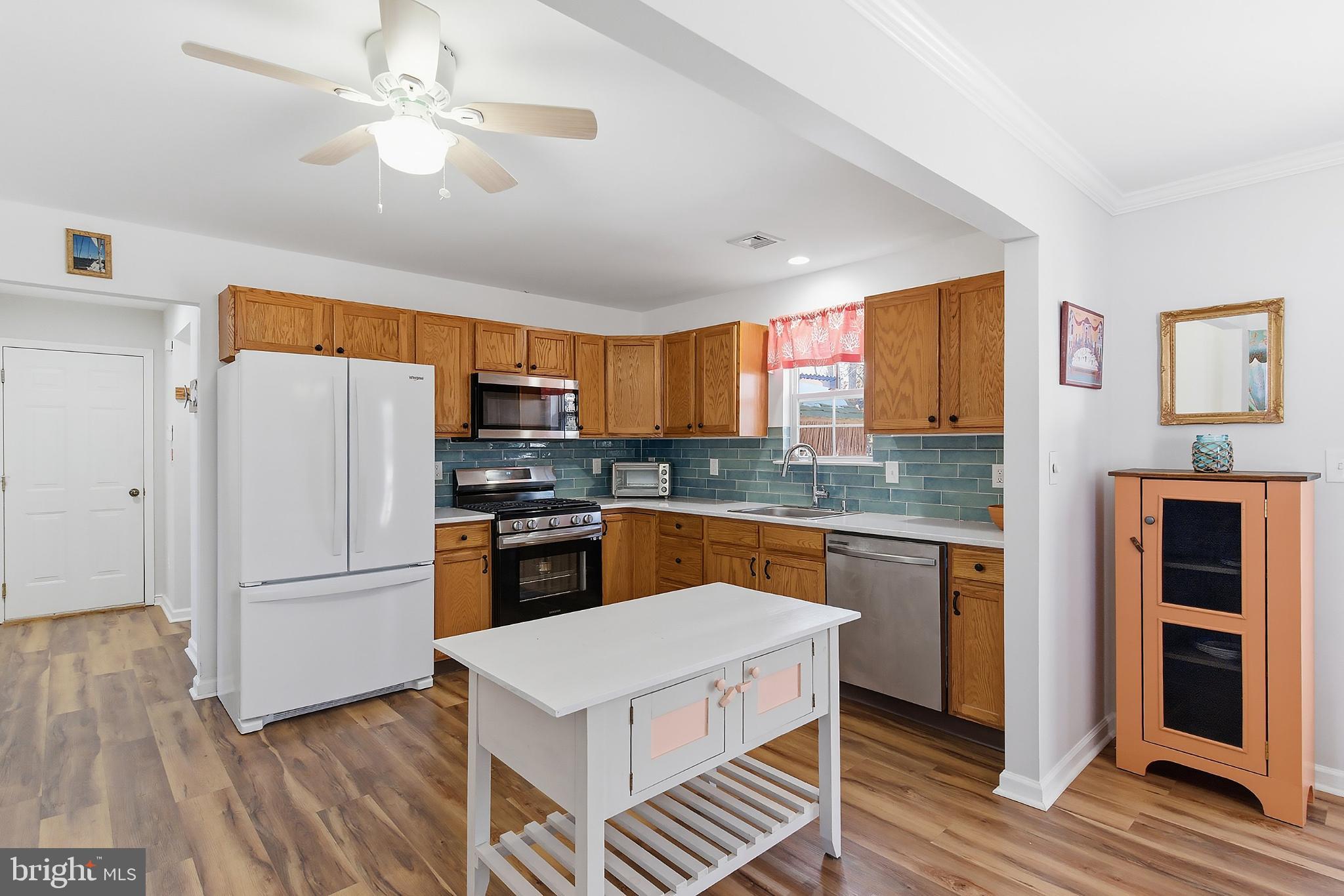 31 Hillcrest Lane Tuckerton, NJ 08087 - Photo 10 of 33 a kitchen with stainless steel appliances granite countertop a refrigerator a sink dishwasher a stove and white countertops with wooden floor