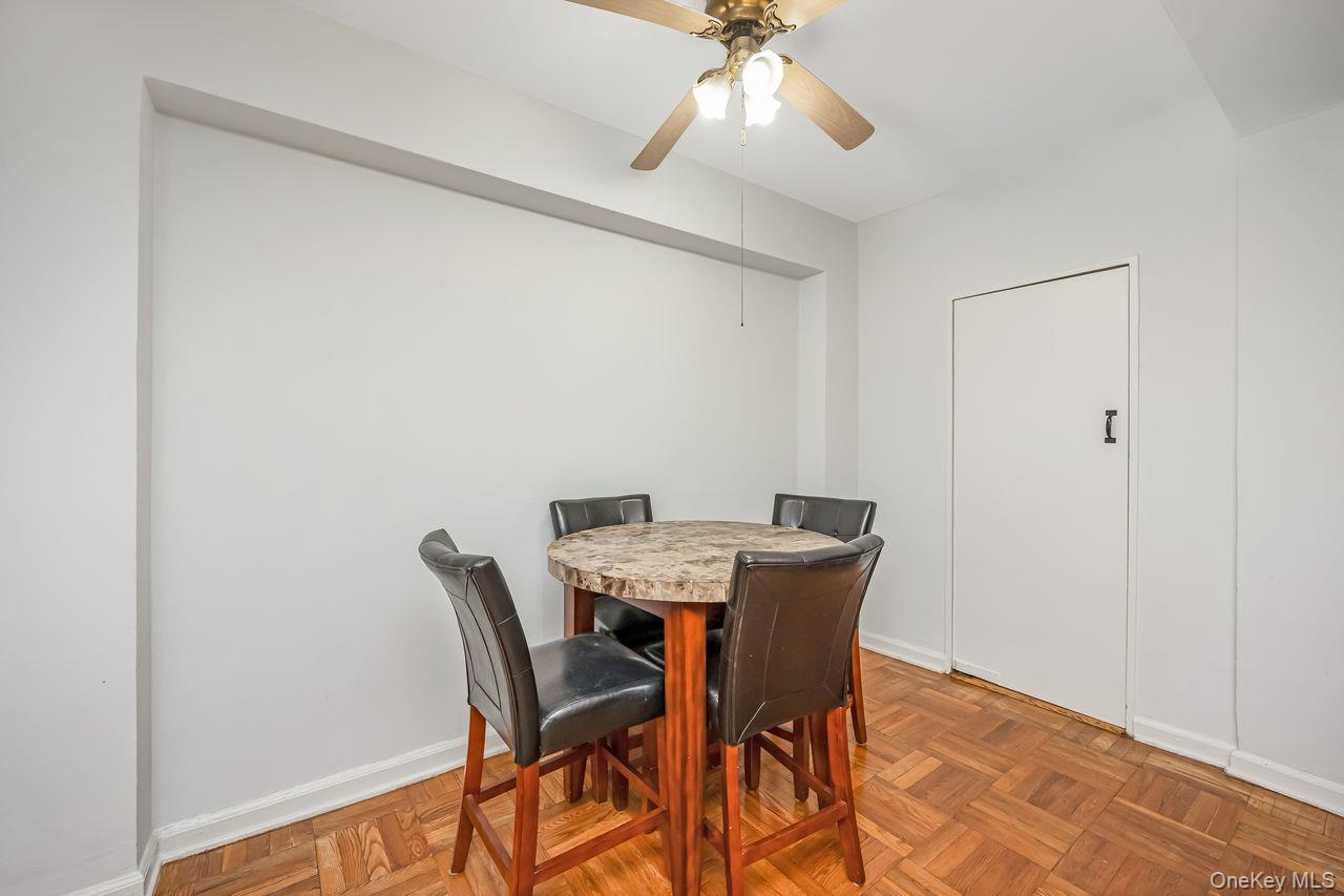 98-50 63rd Drive, Unit 1F Queens, NY 11374 - Photo 11 of 15 a view of a dining room with furniture and wooden floor