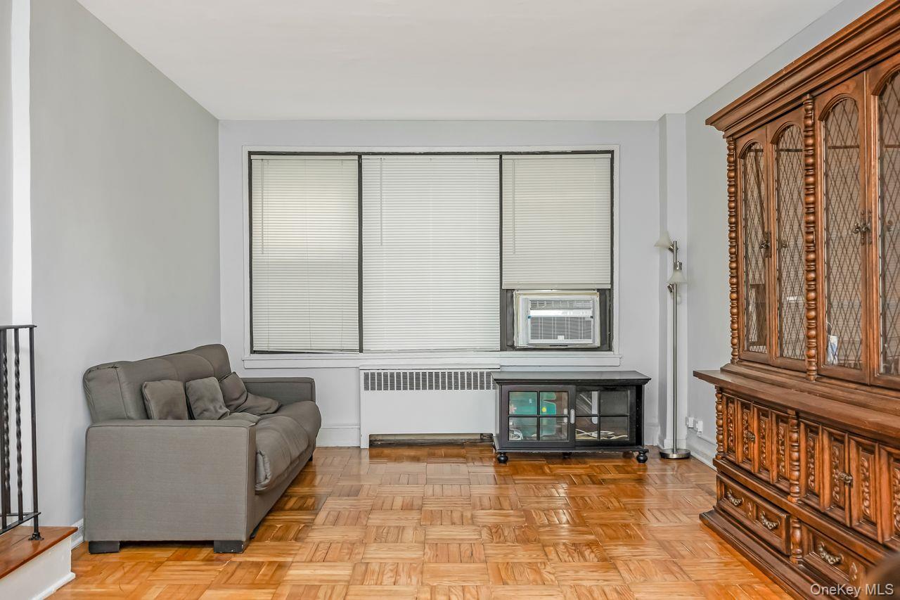 98-50 63rd Drive, Unit 1F Queens, NY 11374 - Photo 3 of 15 a living room with furniture
