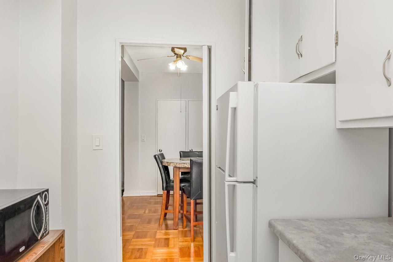 98-50 63rd Drive, Unit 1F Queens, NY 11374 - Photo 8 of 15 a dining room with furniture and a window