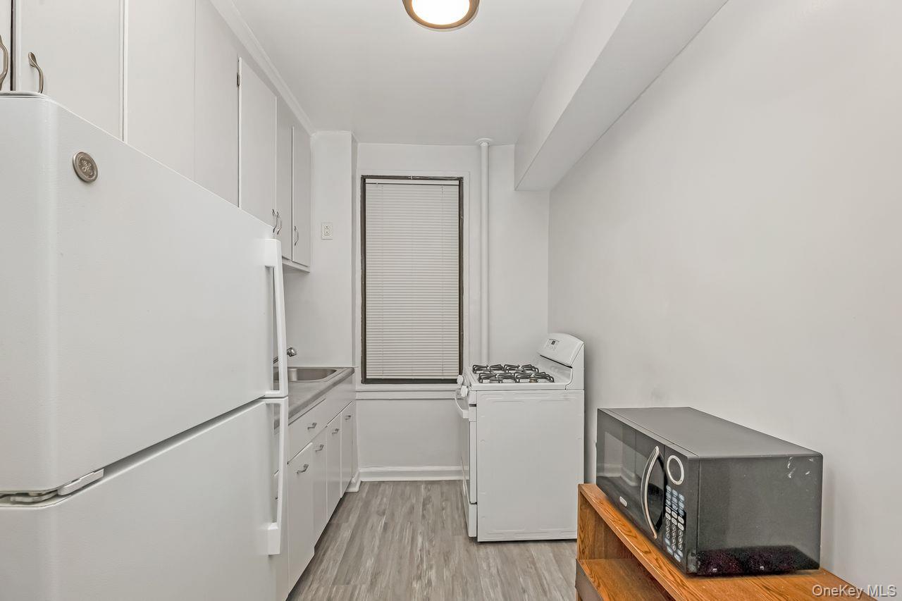 98-50 63rd Drive, Unit 1F Queens, NY 11374 - Photo 10 of 15 a view of front door with wooden floor