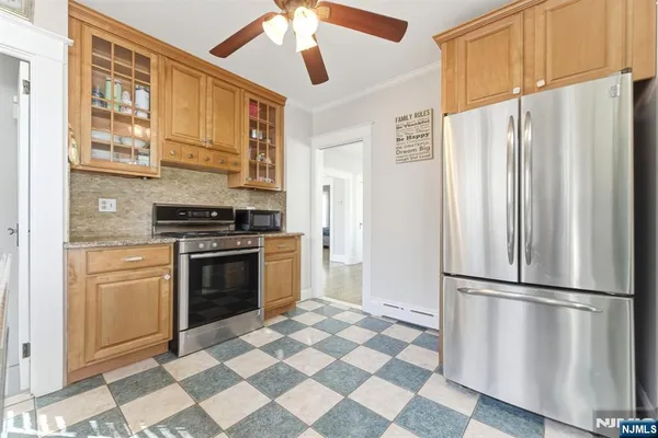 a kitchen with stainless steel appliances a refrigerator sink and stove