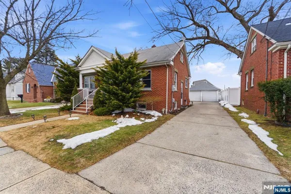 a view of a house with a yard and garage