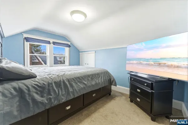 a bedroom with a bed and a night stand