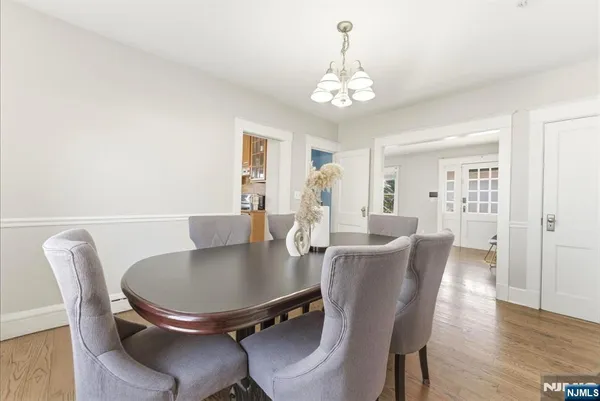 a view of a dining room with furniture wooden floor and chandelier