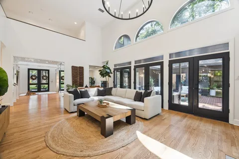 a living room with patio furniture and a large window