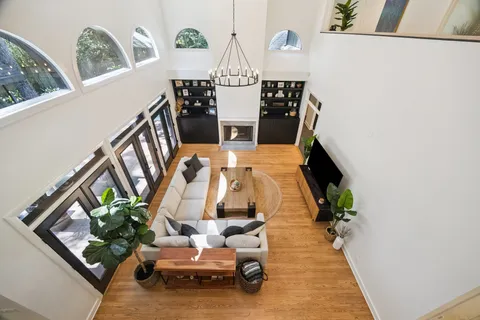 a living room with furniture and a chandelier