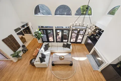 a living room with furniture and a floor to ceiling window