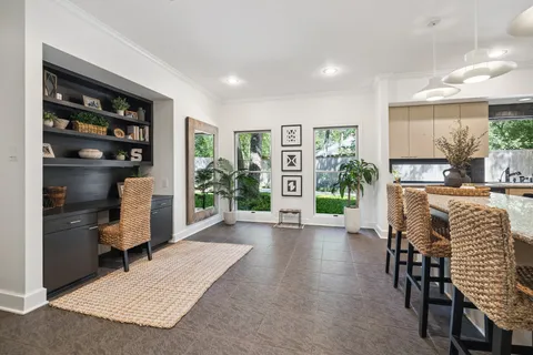 a kitchen with granite countertop white cabinets and stainless steel appliances