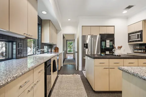 a bathroom with a granite countertop shower and a sink