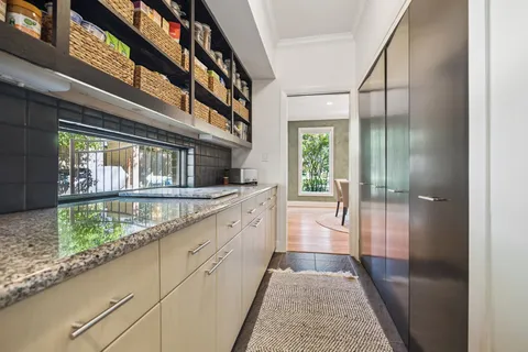 a bathroom with a sink and mirror with bathtub