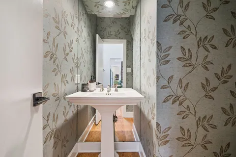 a bathroom with a granite countertop sink a mirror and shower