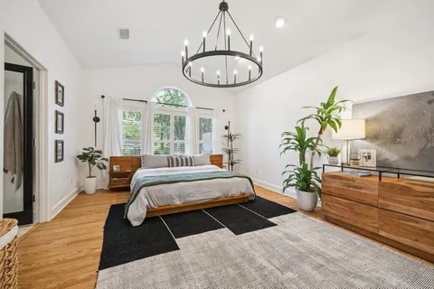a living room with furniture a flat screen tv and a large window